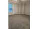 Neutral bedroom offers natural light through the window and carpet flooring at 290 Walker Ave, Alpharetta, GA 30076