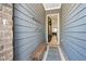 Cozy entryway with stylish grey siding and a wooden bench for added convenience at 290 Walker Ave, Alpharetta, GA 30076