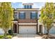 Charming home featuring a brick facade, stylish grey siding, and a two-car garage at 290 Walker Ave, Alpharetta, GA 30076