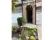 Inviting entrance with an arched doorway and professionally landscaped flower beds at 290 Walker Ave, Alpharetta, GA 30076