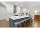 Stylish kitchen featuring a quartz island with seating, white cabinets, and modern pendant lighting at 290 Walker Ave, Alpharetta, GA 30076