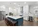 Elegant kitchen with white cabinets, a blue island with seating, and stainless steel appliances at 290 Walker Ave, Alpharetta, GA 30076