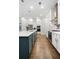 Modern kitchen with white cabinets, a blue island, and stainless steel appliances at 290 Walker Ave, Alpharetta, GA 30076