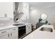 Modern kitchen with white cabinets, stainless steel appliances, and a sleek range hood at 290 Walker Ave, Alpharetta, GA 30076