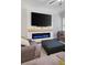 Cozy living room showcasing a modern electric fireplace, large screen television and comfortable sofa set at 290 Walker Ave, Alpharetta, GA 30076