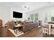 Bright living room featuring a large TV, comfortable seating, and hardwood floors, perfect for relaxation and entertainment at 290 Walker Ave, Alpharetta, GA 30076