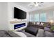 Bright living room featuring an electric fireplace with modern shiplap and a cozy sectional sofa at 290 Walker Ave, Alpharetta, GA 30076