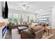 Inviting living room with hardwood floors, plush sectional sofa, fireplace, and plenty of natural light at 290 Walker Ave, Alpharetta, GA 30076