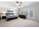 Spacious main bedroom featuring a ceiling fan, bedside tables, and a walkout to a balcony at 290 Walker Ave, Alpharetta, GA 30076
