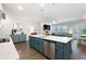 Open-concept kitchen and living area with a central island and stainless steel appliances at 290 Walker Ave, Alpharetta, GA 30076
