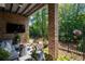 Inviting outdoor patio with comfortable seating, string lights, and a view of the manicured backyard, perfect for entertaining at 290 Walker Ave, Alpharetta, GA 30076
