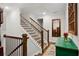 Elegant staircase featuring wood railings, white risers, and a decorative mirror, blending classic design with modern touches at 290 Walker Ave, Alpharetta, GA 30076