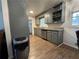 Kitchen featuring stone countertops, stainless dishwasher, wood floors and gray cabinets at 987 Forrest Se Cir, Atlanta, GA 30354