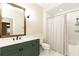 Bathroom with green vanity, shower/tub combo, and white tile at 273 12Th Ne St # 114, Atlanta, GA 30309