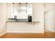 Modern kitchen features a breakfast bar, dark countertops, and white cabinets at 273 12Th Ne St # 114, Atlanta, GA 30309