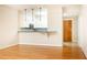 Hardwood floor living room with kitchen and entry views at 273 12Th Ne St # 114, Atlanta, GA 30309