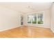 Hardwood floor living room with large windows and patio access at 273 12Th Ne St # 114, Atlanta, GA 30309