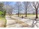 Tree-lined walkway in the park with a person on a scooter at 273 12Th Ne St # 114, Atlanta, GA 30309