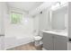 Updated bathroom with a tub, toilet and gray vanity at 558 Plainville Dr, Atlanta, GA 30331