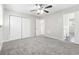 Spacious bedroom featuring gray carpet, ceiling fan and double doors at 558 Plainville Dr, Atlanta, GA 30331