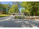 Gray house with white picket fence, driveway, and mature trees at 558 Plainville Dr, Atlanta, GA 30331