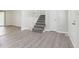 Bright living area with gray flooring and stairs at 558 Plainville Dr, Atlanta, GA 30331