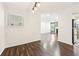 Simple dining area with hardwood floors and view to living room at 2015 Huntingdon, Atlanta, GA 30350