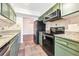 Galley kitchen with green cabinets and granite countertops at 2015 Huntingdon, Atlanta, GA 30350