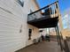 Partial view of the raised wood deck overlooking the concrete slab backyard patio at 4908 Topsfield Ln, Lithonia, GA 30038