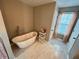 Spa-like bathroom with a soaking tub and marble flooring at 4908 Topsfield Ln, Lithonia, GA 30038