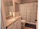 Bathroom featuring granite countertop, white cabinets, and a shower with patterned curtain at 4908 Topsfield Ln, Lithonia, GA 30038