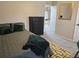 Bedroom features a bed, black dresser, accent rug, and a view of the upstairs hall at 4908 Topsfield Ln, Lithonia, GA 30038