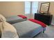 Bedroom showcasing twin beds with neutral walls, carpeted floors, and a black dresser at 4908 Topsfield Ln, Lithonia, GA 30038