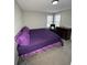 Bright bedroom featuring plush carpet, a comfy chair, and a dark wood dresser at 4908 Topsfield Ln, Lithonia, GA 30038