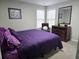 Cozy bedroom with a plush bed, a patterned rug, and two windows for natural light at 4908 Topsfield Ln, Lithonia, GA 30038