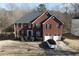 Beautiful brick home featuring an attached two car garage and manicured front lawn at 4908 Topsfield Ln, Lithonia, GA 30038