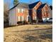 Two-story brick home with attached garage and landscaped yard at 4908 Topsfield Ln, Lithonia, GA 30038