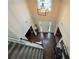 Bright, airy foyer with hardwood flooring, decorative lighting, and a view of the front door and staircase at 4908 Topsfield Ln, Lithonia, GA 30038