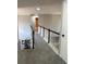 Upper level hallway with carpeted floor and railing at 4908 Topsfield Ln, Lithonia, GA 30038