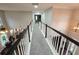 Hallway looking down into the living room showcasing the open layout and hardwood floors at 4908 Topsfield Ln, Lithonia, GA 30038