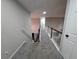 Upstairs hallway features neutral walls, carpeted floors, and a classic black and white railing at 4908 Topsfield Ln, Lithonia, GA 30038