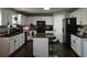 Kitchen boasts white cabinets, granite counters and an island at 4908 Topsfield Ln, Lithonia, GA 30038