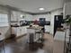 Well-lit kitchen featuring white cabinets, an island with seating, and black appliances at 4908 Topsfield Ln, Lithonia, GA 30038