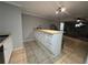 Kitchenette featuring tile floors, a breakfast bar, and white cabinets, creating a functional space at 4908 Topsfield Ln, Lithonia, GA 30038