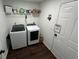 Laundry room featuring modern washer and dryer, a shelf, and laminate flooring at 4908 Topsfield Ln, Lithonia, GA 30038