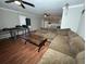 Spacious living room featuring a large sectional sofa and wood flooring at 4908 Topsfield Ln, Lithonia, GA 30038