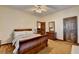 Spacious bedroom with a wooden sleigh bed and ample closet space at 5762 Lilburn Stone Mountain Rd, Stone Mountain, GA 30087