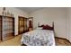 Cozy bedroom featuring a double bed, built-in shelving, and hardwood floors at 5762 Lilburn Stone Mountain Rd, Stone Mountain, GA 30087