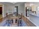 Bright dining room with oval table, chairs and kitchen view at 5762 Lilburn Stone Mountain Rd, Stone Mountain, GA 30087