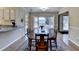 Bright dining room featuring hardwood floors and an oval wooden table with chairs at 5762 Lilburn Stone Mountain Rd, Stone Mountain, GA 30087